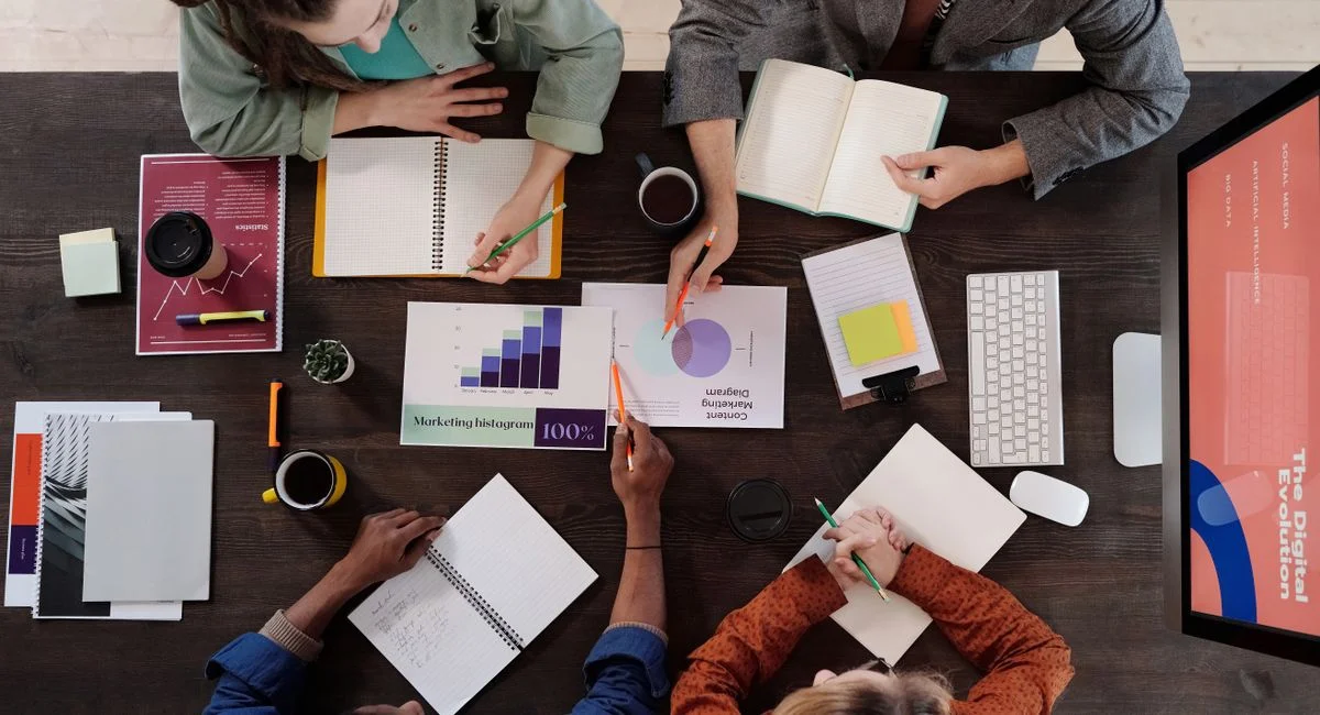 Overhead view of diverse professionals collaborating on a project in a modern office setting.